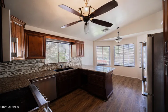 a kitchen with a sink appliances and a window
