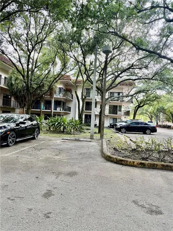a front view of a building with trees