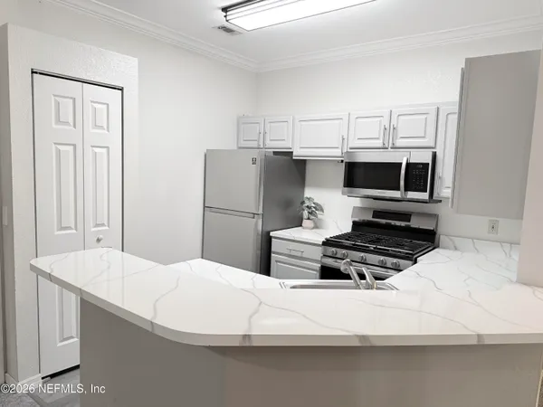 a kitchen with a refrigerator and a sink