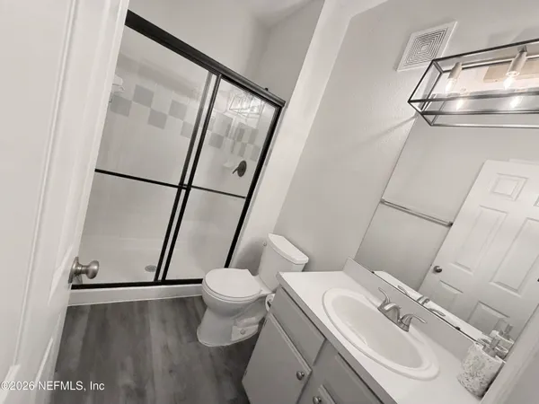 a bathroom with a sink toilet and shower