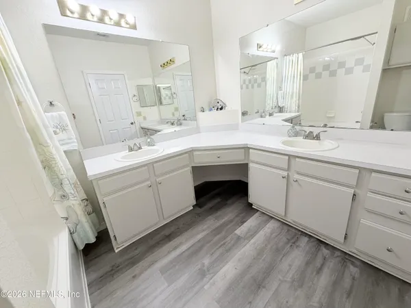 a spacious bathroom with a double vanity sink mirror and