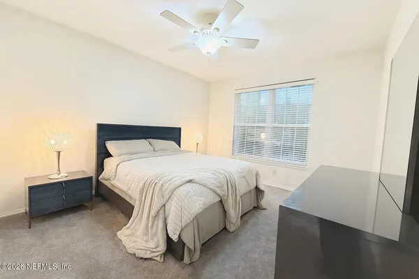 a bedroom with a bed and window