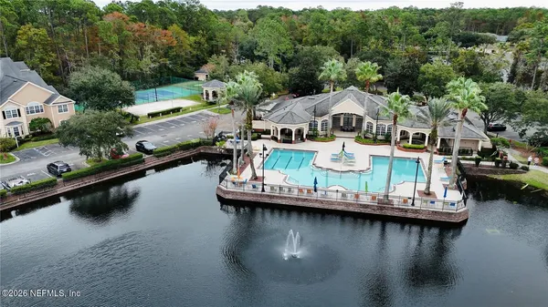 an aerial view of a house with swimming pool having outdoor seating