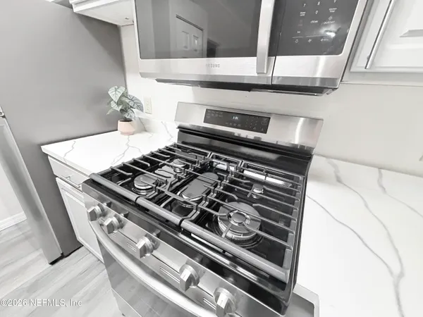 a stove top oven sitting inside of a kitchen