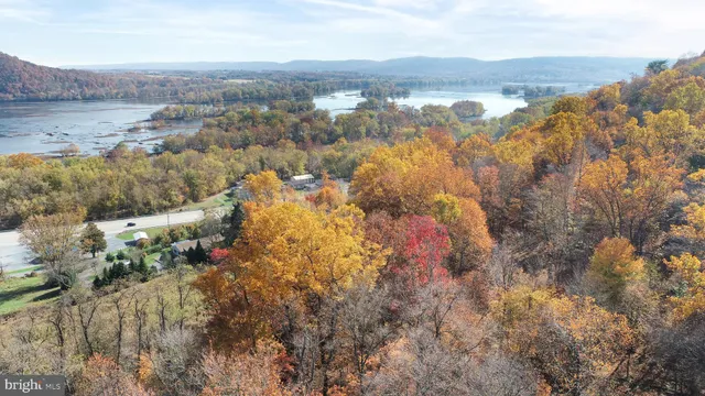 an aerial view of house with yard and mountain view