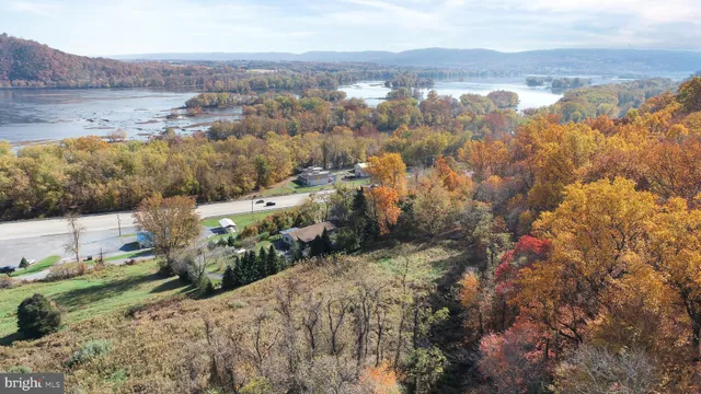 an aerial view of house with yard and mountain view in back