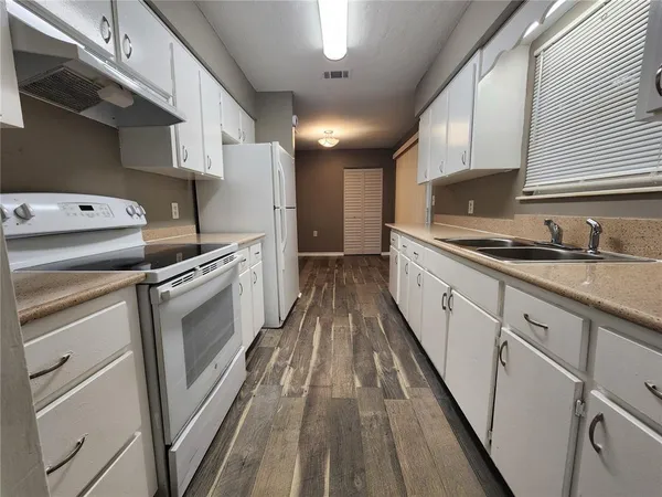 a kitchen with cabinets a sink and appliances