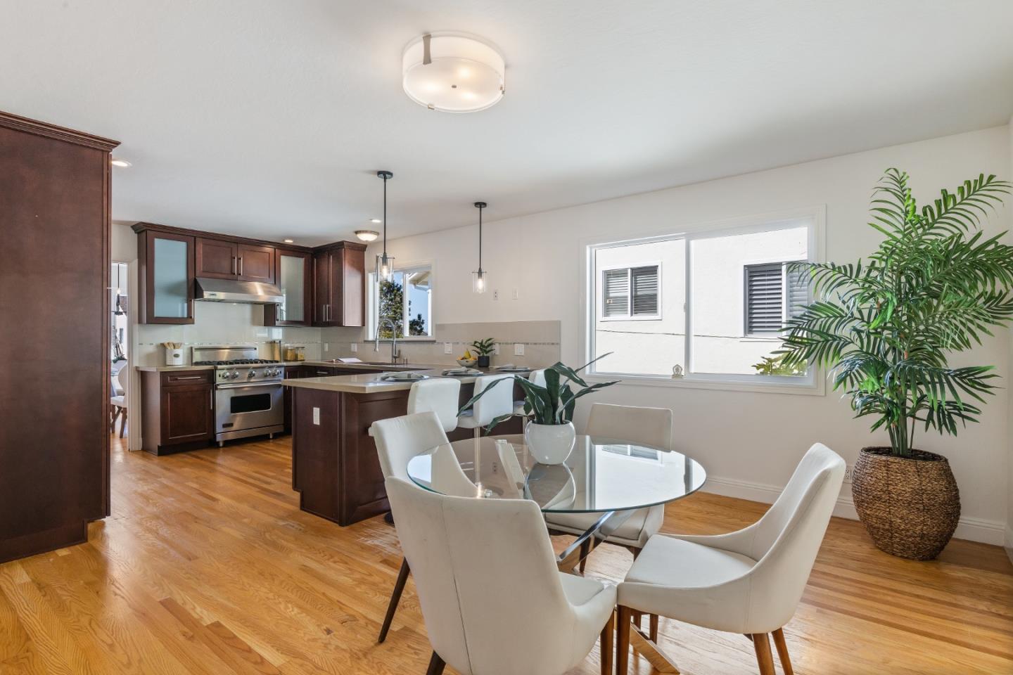 735 Clearfield Drive Millbrae, CA 94030 - Photo 20 of 64 a kitchen with stainless steel appliances granite countertop a kitchen island a stove a table and chairs