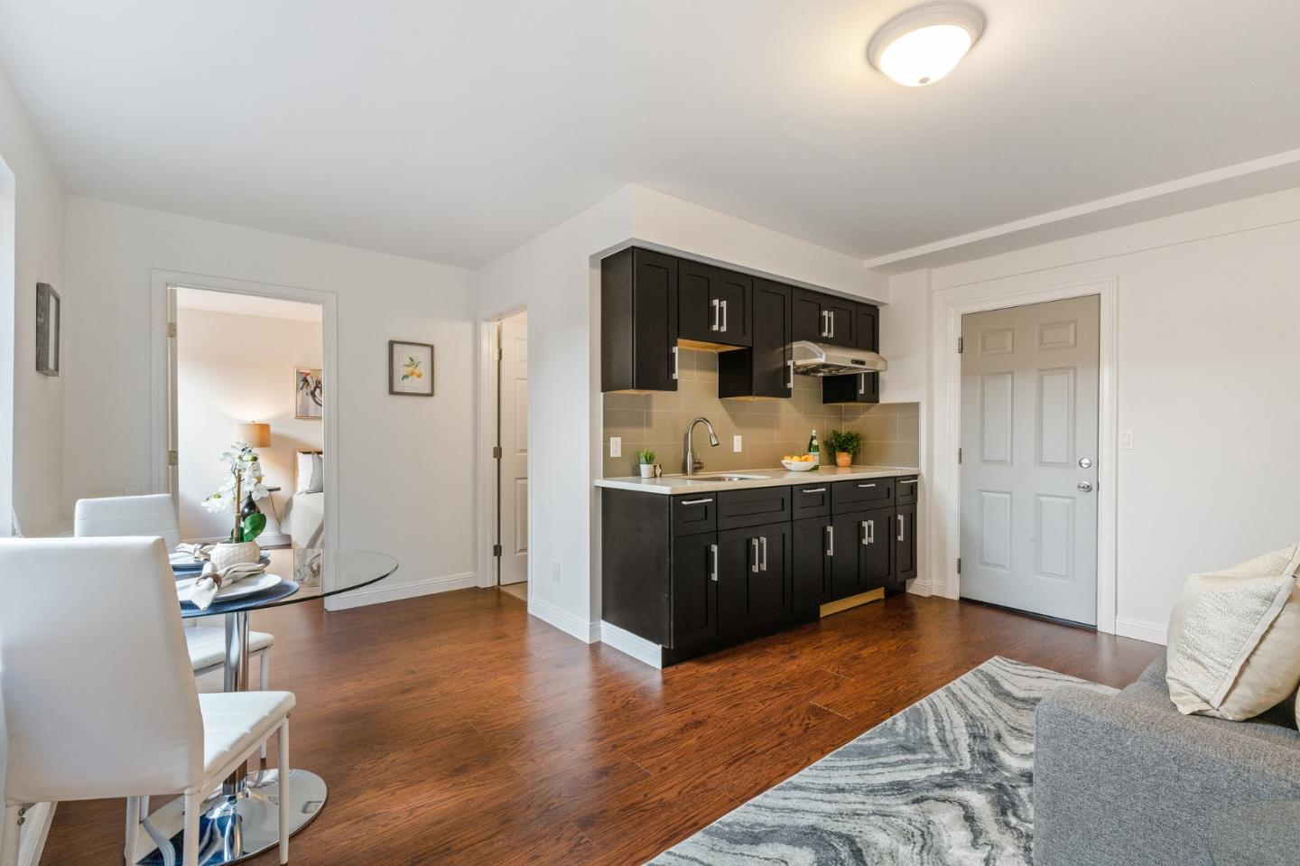 735 Clearfield Drive Millbrae, CA 94030 - Photo 52 of 64 a spacious bedroom with a bed and wooden floor