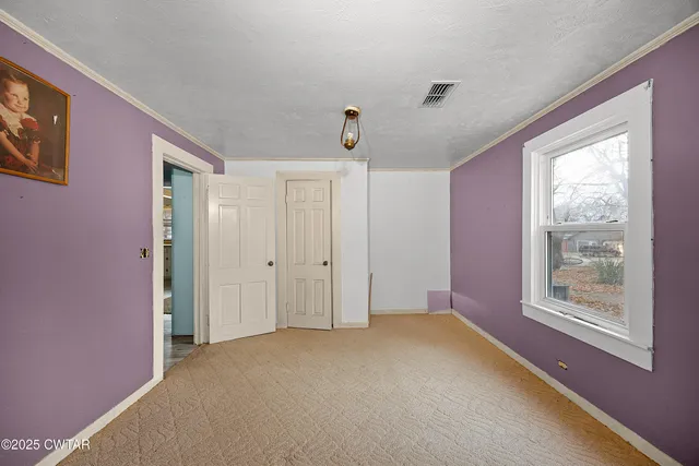 a view of an empty room with a window