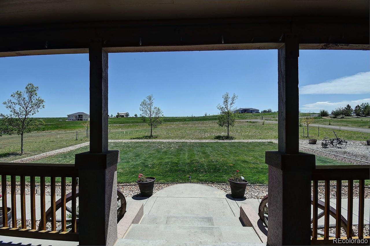 14855 Almstead Street Hudson, CO 80642 - Photo 2 of 39 a view of a street from a yard