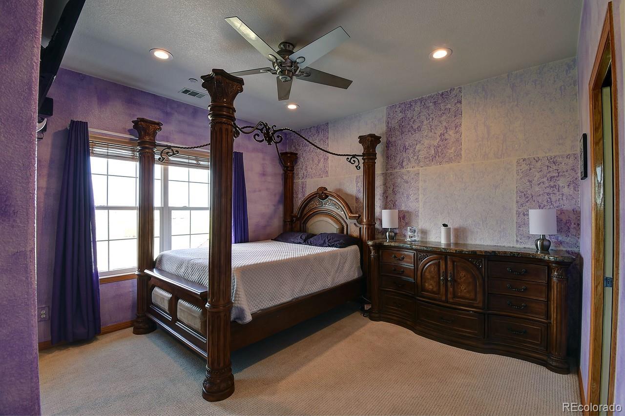 14855 Almstead Street Hudson, CO 80642 - Photo 21 of 39 a bedroom with a bed and a dresser