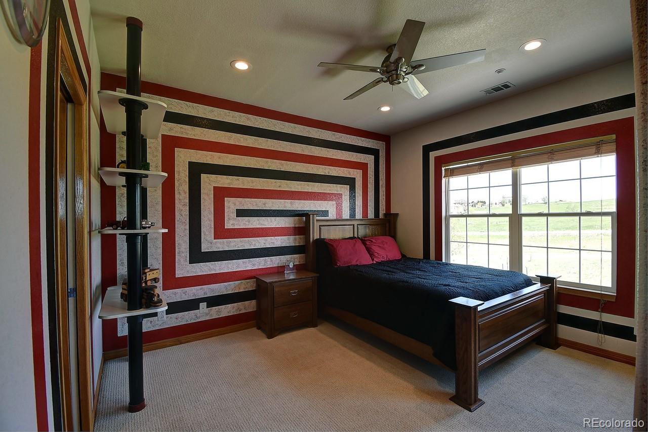 14855 Almstead Street Hudson, CO 80642 - Photo 24 of 39 a bed sitting in a room next to a window