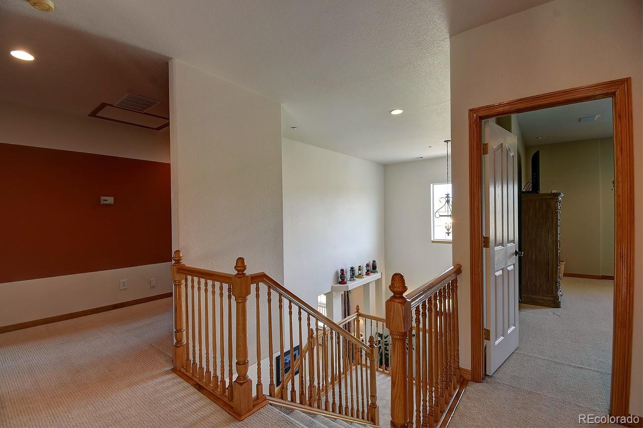 14855 Almstead Street Hudson, CO 80642 - Photo 29 of 39 a view of a hallway with a livingroom with furniture