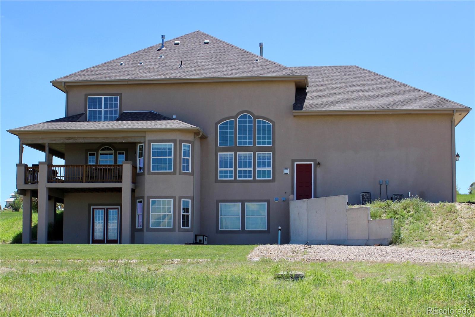 14855 Almstead Street Hudson, CO 80642 - Photo 35 of 39 a front view of a house with a yard