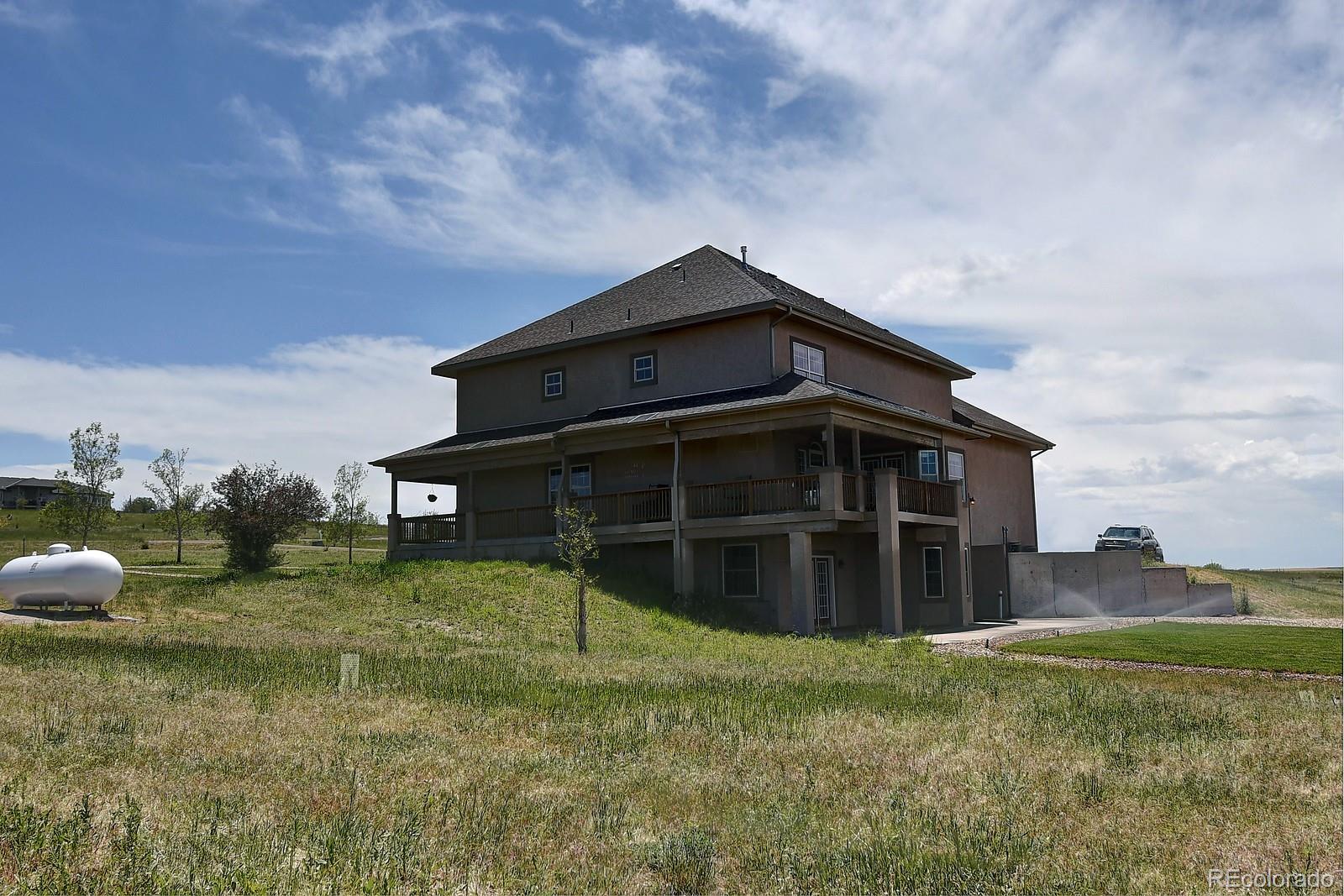 14855 Almstead Street Hudson, CO 80642 - Photo 39 of 39 a view of a house with a yard
