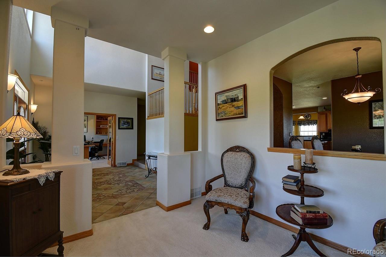 14855 Almstead Street Hudson, CO 80642 - Photo 4 of 39 a view of a livingroom with furniture and a large window