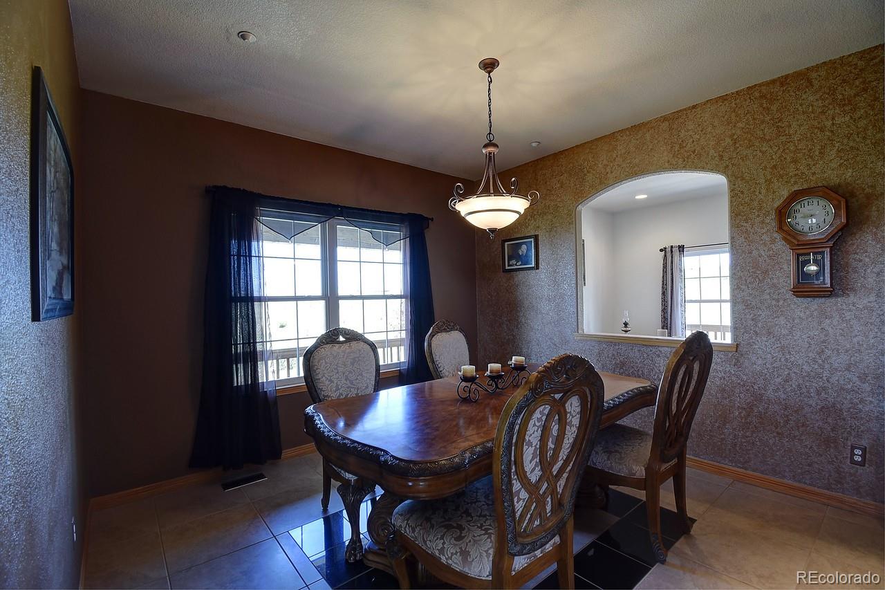 14855 Almstead Street Hudson, CO 80642 - Photo 5 of 39 a view of a dining room with furniture window and wooden floor
