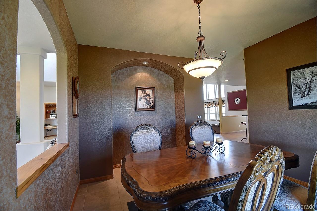 14855 Almstead Street Hudson, CO 80642 - Photo 6 of 39 a view of a dining room with furniture and wooden floor