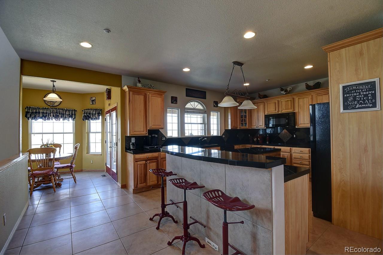14855 Almstead Street Hudson, CO 80642 - Photo 7 of 39 a kitchen with stainless steel appliances lots of counter top space