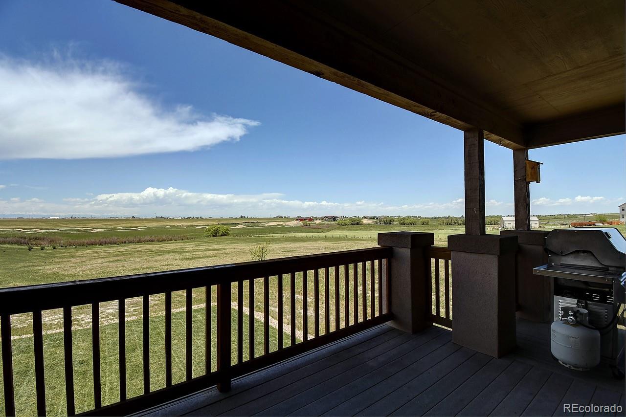 14855 Almstead Street Hudson, CO 80642 - Photo 10 of 39 a view of a balcony with an ocean view