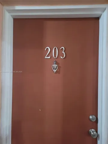 a living room with furniture a dining table and a piano table