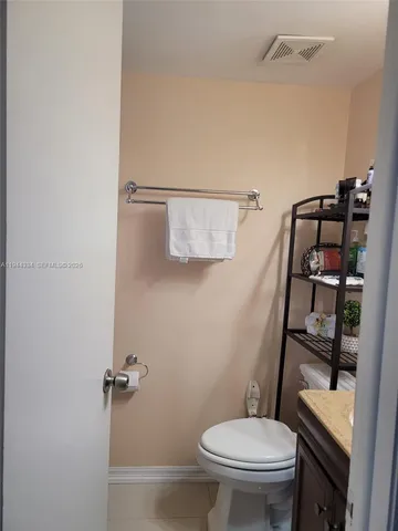 a table with a potted plant and a wooden floor