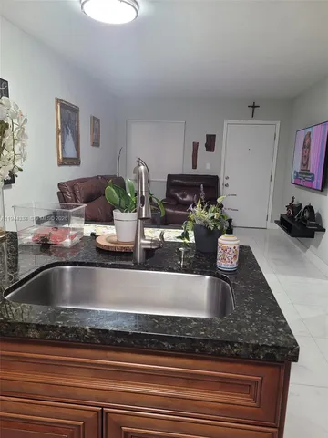 a kitchen with granite countertop cabinets and white appliances