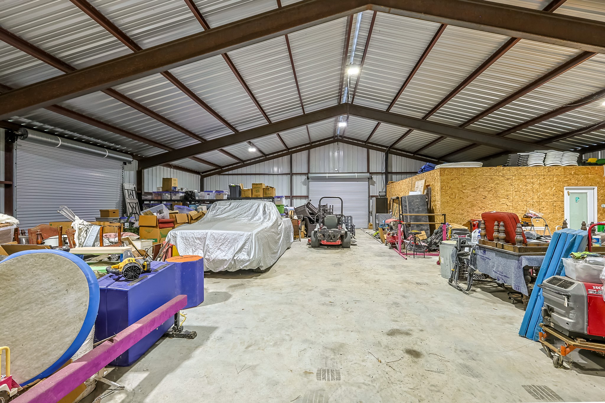 6409 Medley Road New Waverly, TX 77358 - Photo 43 of 50 This shop is 60X40 with large roll-up doors on 3 sides and an office or apartment built inside.