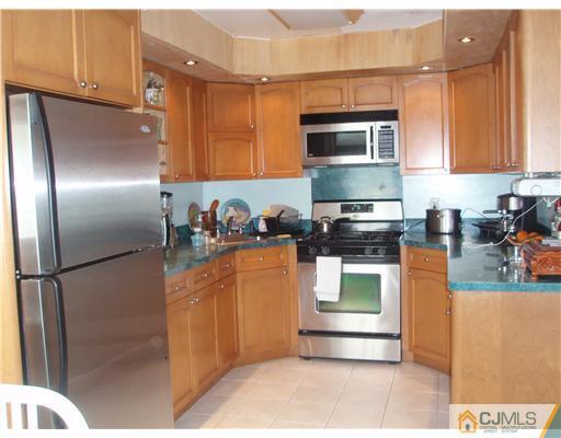 67 Idlewild Road Edison, NJ 08817 - Photo 2 of 6 a kitchen with stainless steel appliances granite countertop a refrigerator a stove top oven and a sink