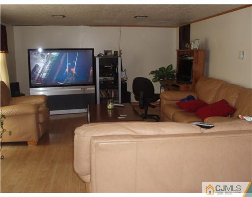 67 Idlewild Road Edison, NJ 08817 - Photo 3 of 6 a living room with furniture and a flat screen tv