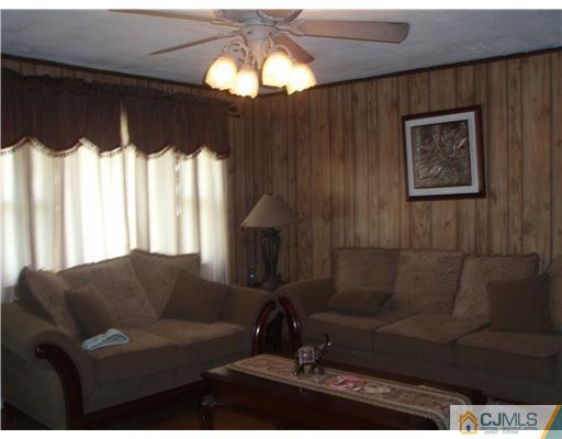 67 Idlewild Road Edison, NJ 08817 - Photo 5 of 6 a living room with furniture and a chandelier