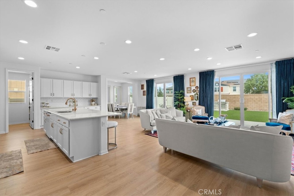 34490 Bloomberry Road Murrieta, CA 92563 - Photo 11 of 43 a living room with stainless steel appliances kitchen island hardwood floor sink and a large window
