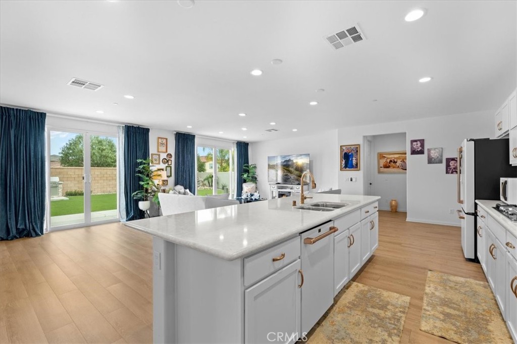 34490 Bloomberry Road Murrieta, CA 92563 - Photo 17 of 43 a large kitchen with stainless steel appliances granite countertop a large counter top and mountain view