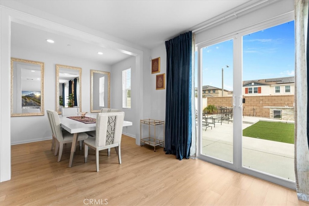 34490 Bloomberry Road Murrieta, CA 92563 - Photo 19 of 43 a dining room with furniture a rug and kitchen view