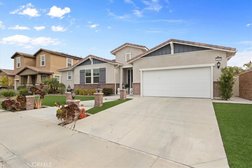 34490 Bloomberry Road Murrieta, CA 92563 - Photo 2 of 43 a front view of a house with a yard and garage