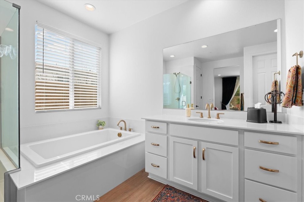34490 Bloomberry Road Murrieta, CA 92563 - Photo 23 of 43 a spacious bathroom with a double vanity sink a bathtub and next to a window