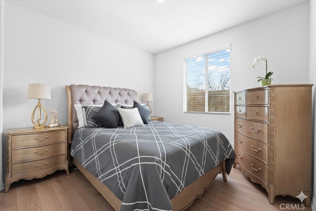 34490 Bloomberry Road Murrieta, CA 92563 - Photo 24 of 43 a bed sitting in a bedroom next to a window and dresser