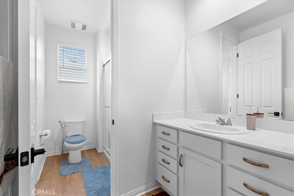 34490 Bloomberry Road Murrieta, CA 92563 - Photo 27 of 43 a bathroom with a sink a toilet and a mirror