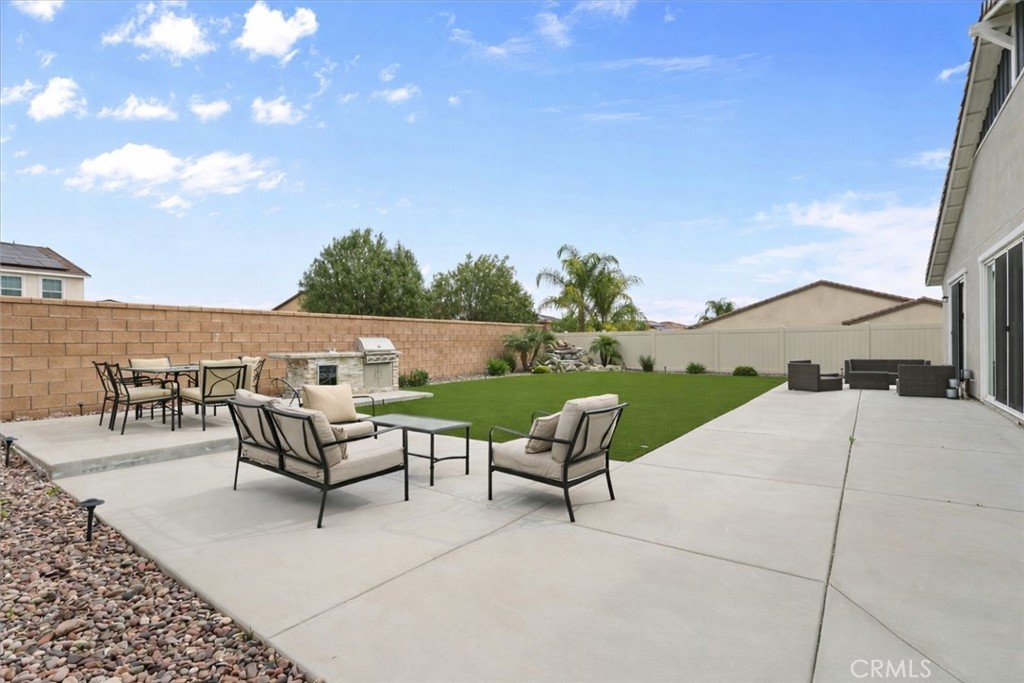 34490 Bloomberry Road Murrieta, CA 92563 - Photo 32 of 43 a swimming pool with outdoor seating and yard