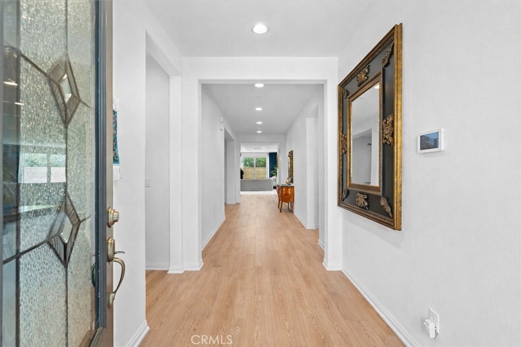 34490 Bloomberry Road Murrieta, CA 92563 - Photo 5 of 43 a view of a hallway with wooden floor and glass door
