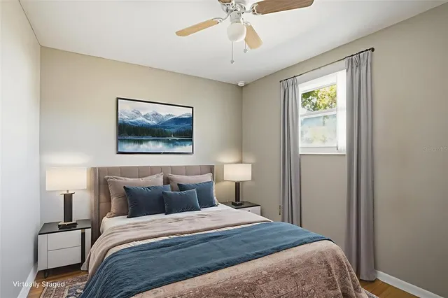 a bedroom with a bed and a painting on the wall