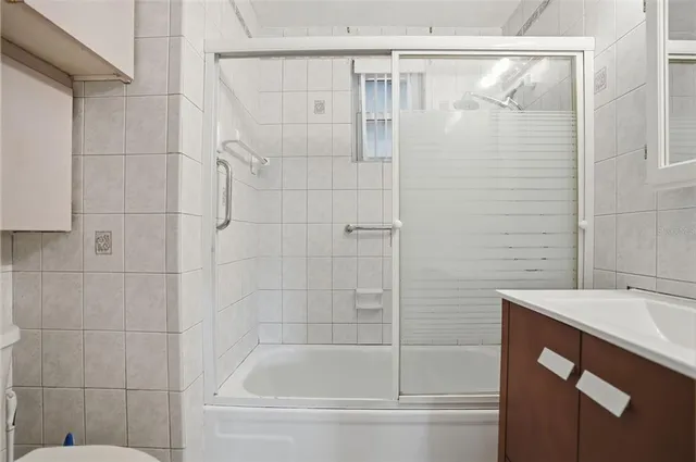a bathroom with a bathtub and shower