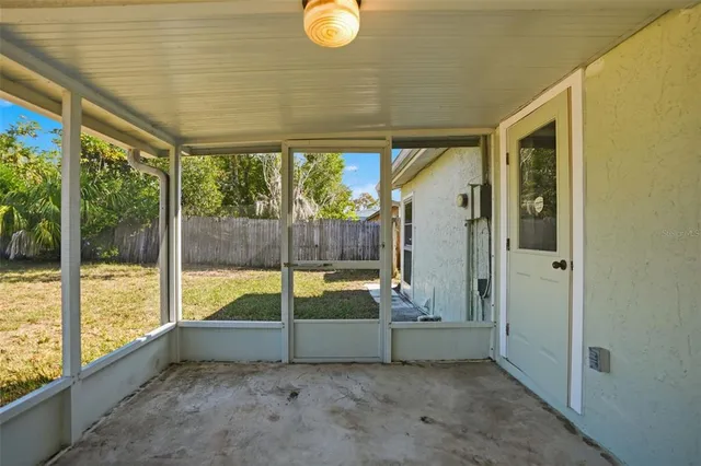 a view of backyard with tub and door