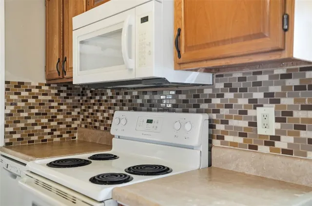a kitchen with a stove and a white cabinet