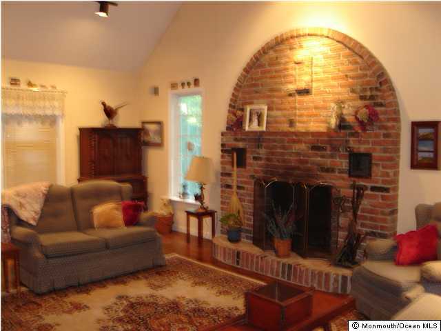 211 Old Mill Road Freehold, NJ 07728 - Photo 3 of 3 a living room with furniture and a fireplace