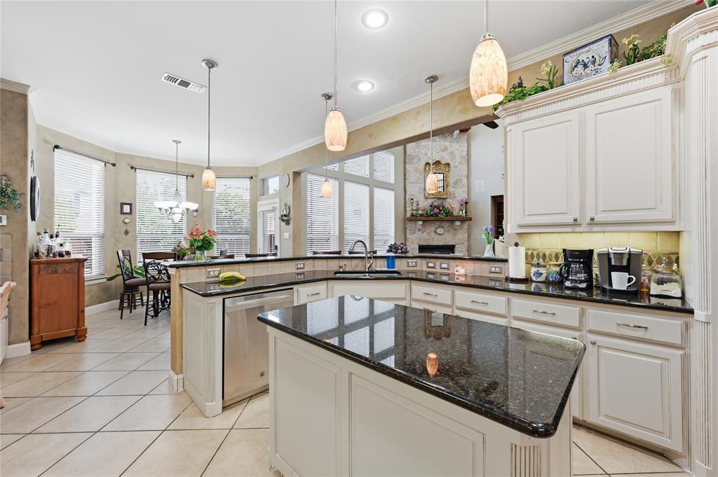 1316 Rio Grande Drive Allen, TX 75013 - Photo 13 of 40 a kitchen with stainless steel appliances granite countertop a sink a stove and cabinets