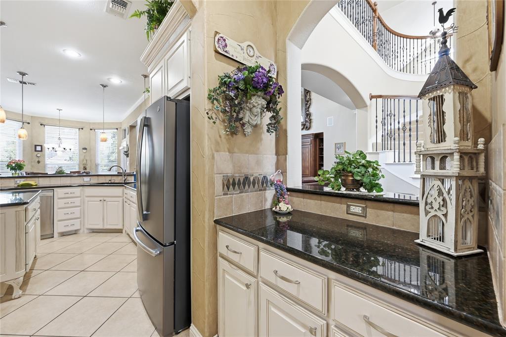 1316 Rio Grande Drive Allen, TX 75013 - Photo 14 of 40 a kitchen with stainless steel appliances granite countertop a refrigerator a oven and white cabinets