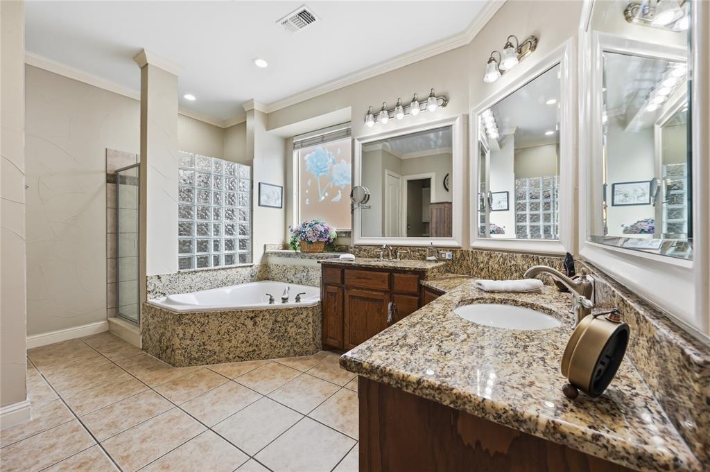 1316 Rio Grande Drive Allen, TX 75013 - Photo 18 of 40 a spacious bathroom with a granite countertop tub sink and mirror