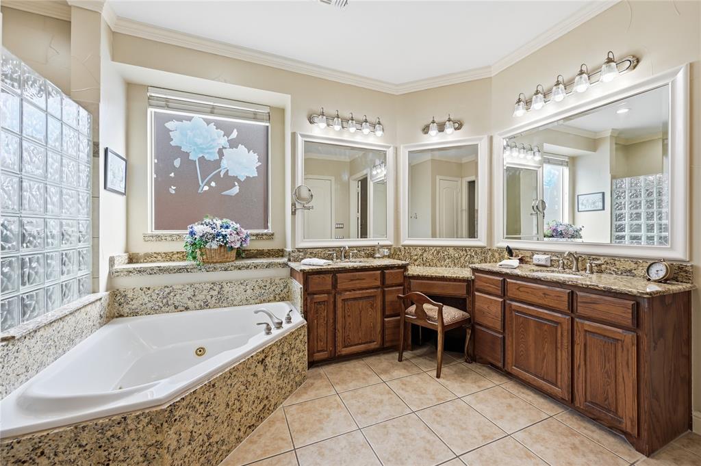 1316 Rio Grande Drive Allen, TX 75013 - Photo 19 of 40 a spacious bathroom with a granite countertop tub sink and mirror